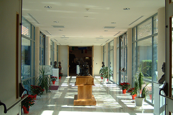 A hallway inside the US Army Medical Museum with floor to ceiling windows on both sides.